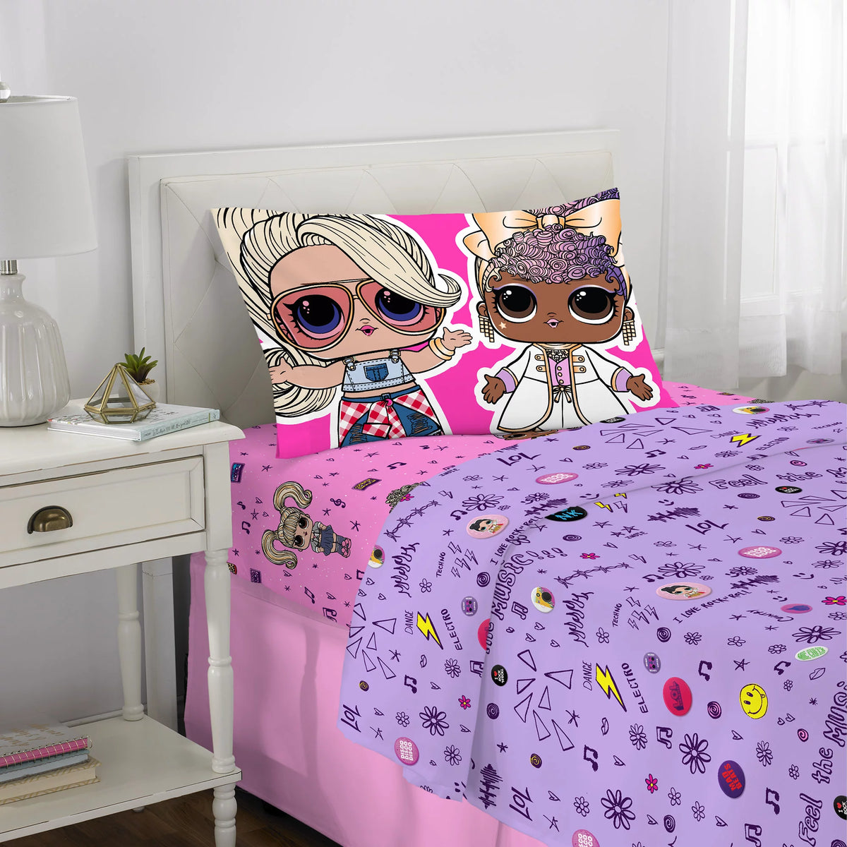 Twin bed with pink and purple sheets and a pillowcase of two fashion dolls