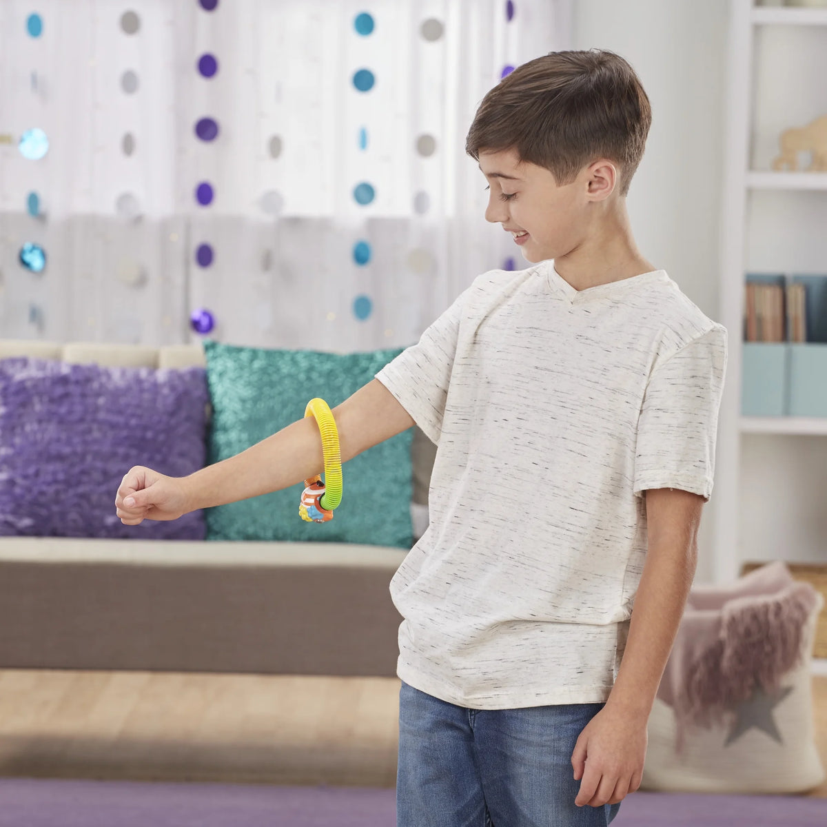 Boy watching the spring toy climb along his outstretched arm