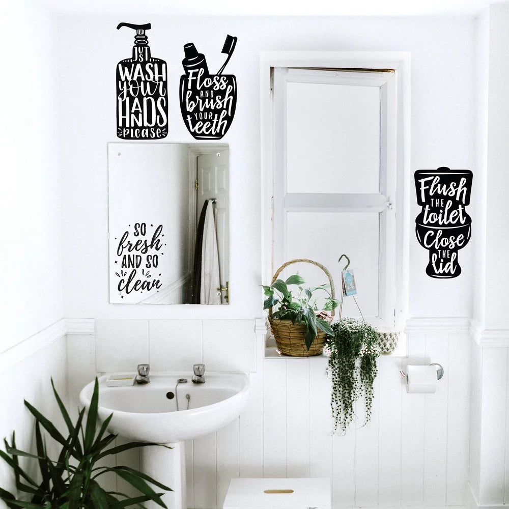 White bathroom with the soap, toothbrush cup and toilet decals on the walls and mirror