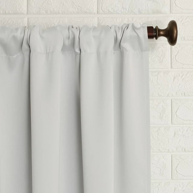 Close-up of the gathered rod pocket top on a bronze curtain rod
