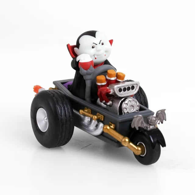 Vampire kid figure in a cape driving a black coffin hot rod with bat ornament