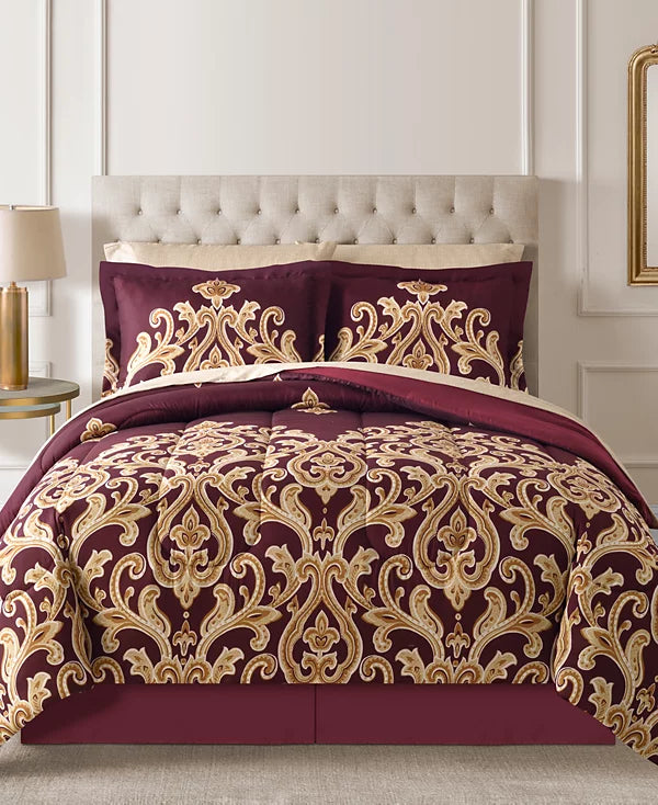 Burgundy and gold damask comforter set with matching shams and bed skirt on a tufted bed