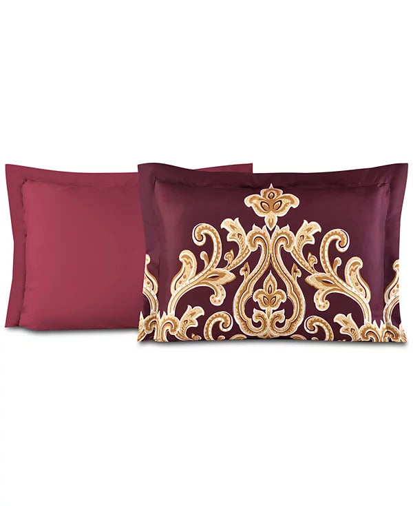 Two pillow shams, one solid red and one burgundy with a gold damask print