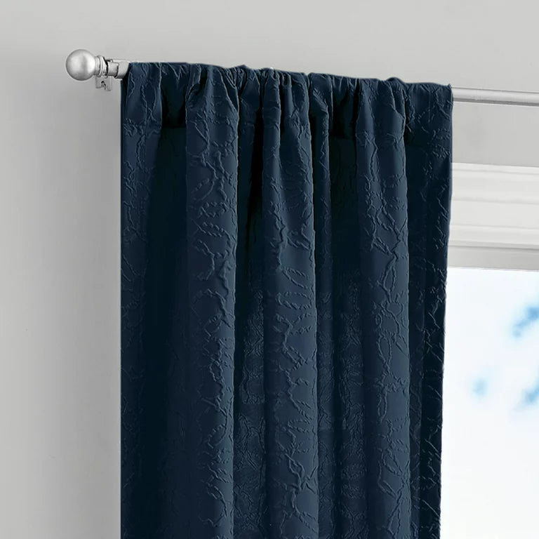Rod pocket top of the navy embossed curtain on a silver rod