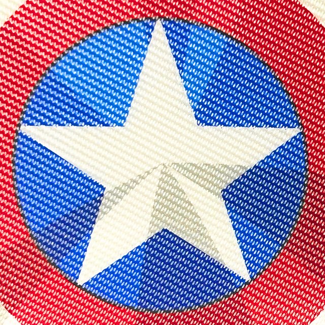 Close-up of the white star on the blue centre of the shield-print paddle surface