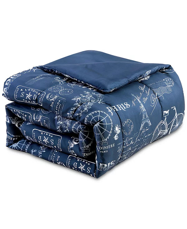 Folded navy Paris print comforter with the solid navy reverse side on top