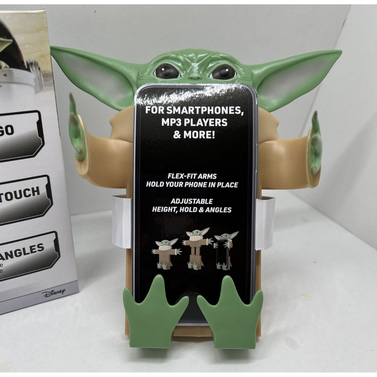 Grogu phone stand with flexible arms and feet holding a sample phone card