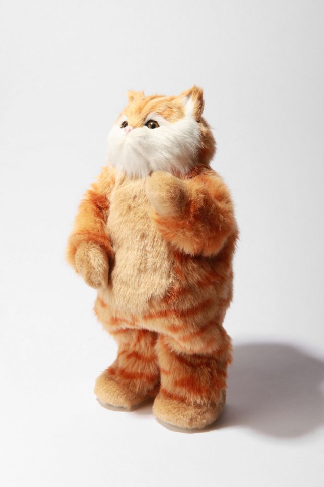 Ginger tabby plush dancing cat with a white chest, looking up