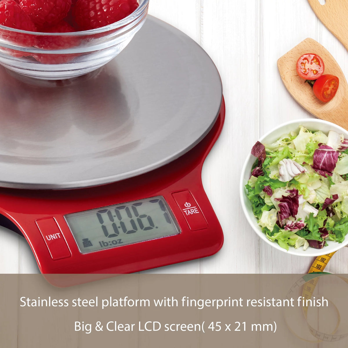 Close-up of the red scale's LCD showing a lb:oz reading beside a salad bowl