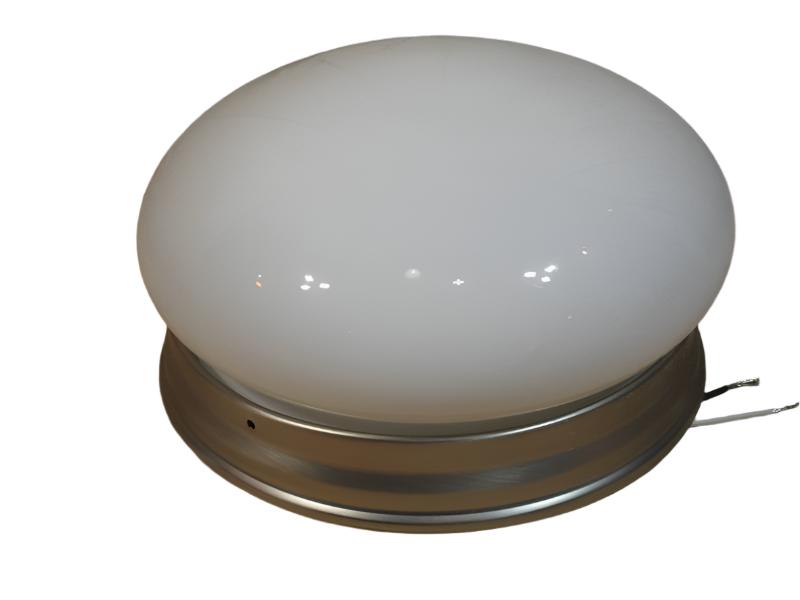 White glass dome sitting on the brushed nickel base with wires showing