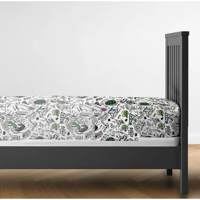 Side view of a dark bed frame with the fitted doodle-print sheet