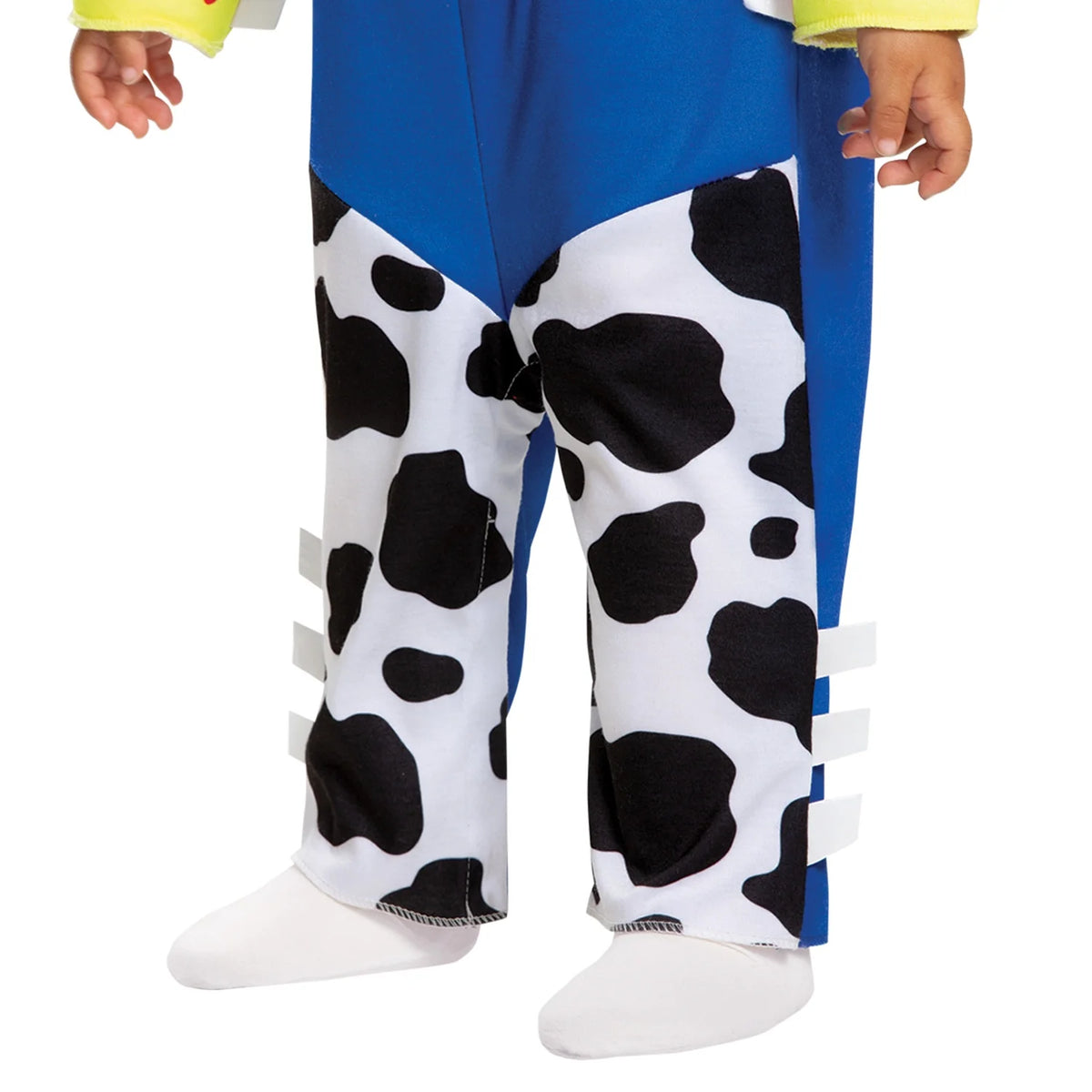 Close-up of the black and white cow-print chaps on blue jumpsuit legs