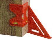 Orange plastic post level strapped to a wooden post beside a matching rafter square