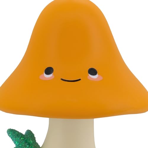 Close-up of the mushroom's orange cap with a sweet smiling face
