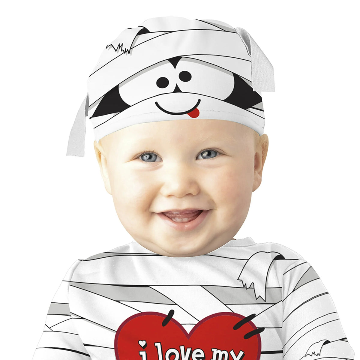 Smiling baby in a bandage-print cap with a cartoon mummy face
