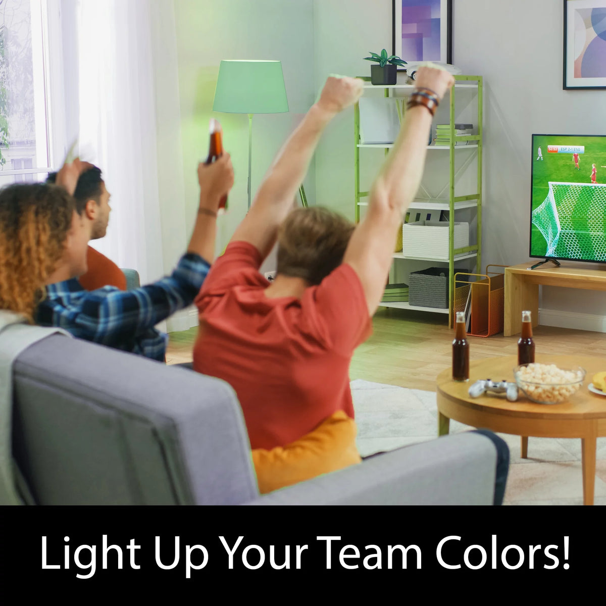 Friends cheering at a football game on TV under a green floor lamp, Light Up Your Team Colors
