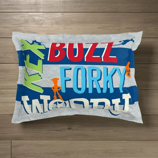Close-up of the Toy Story sham on the comforter beside a Buzz toy