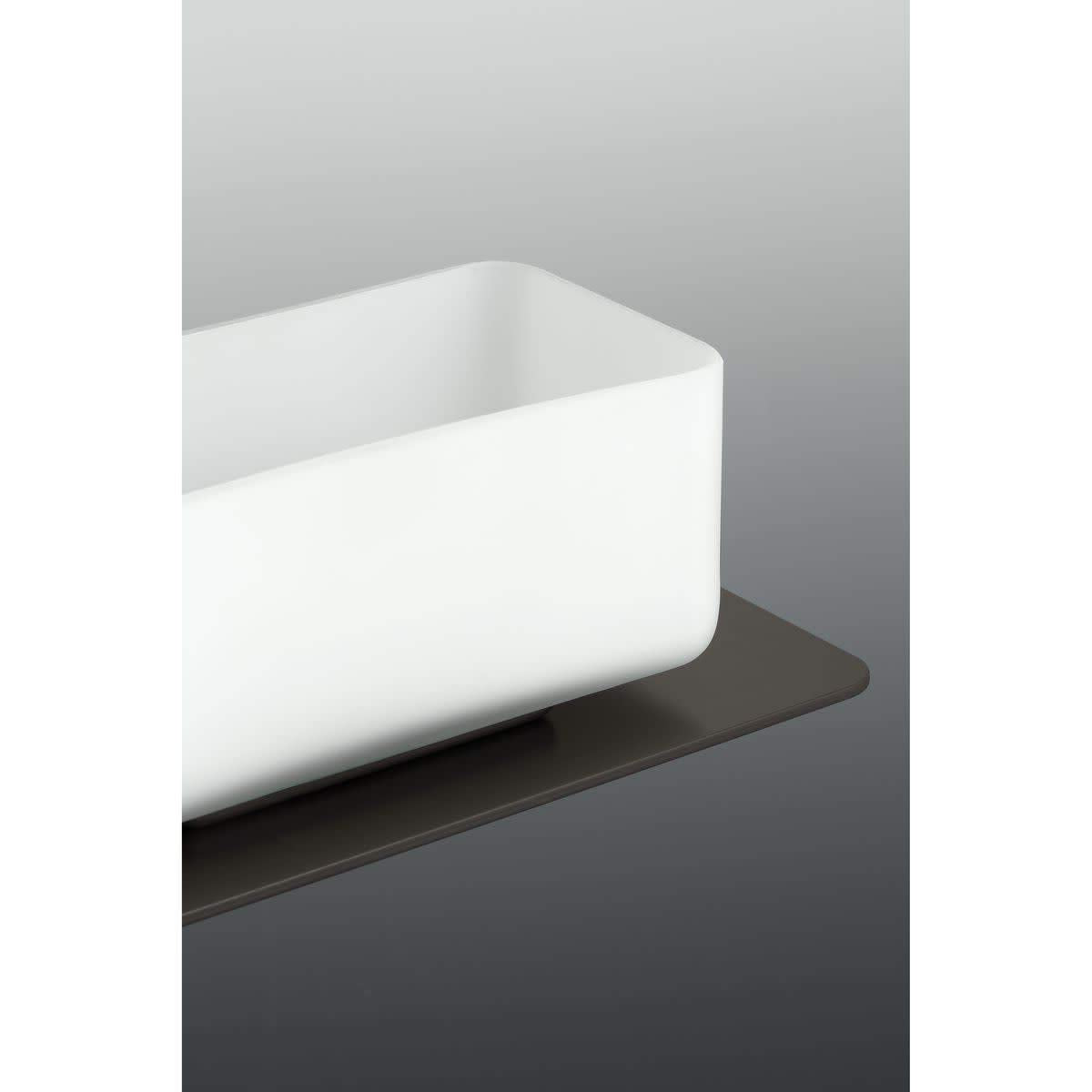 Close-up of a white rectangular glass shade on the dark bronze base
