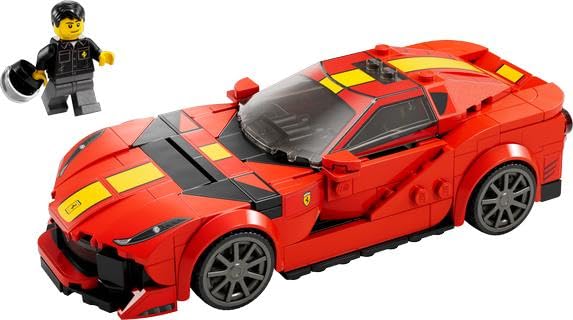 Red brick supercar with yellow stripes beside a driver minifigure holding a helmet