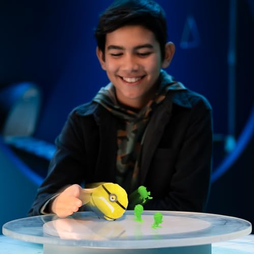 Smiling boy rolling the round yellow figure into green roach figures on a glass table