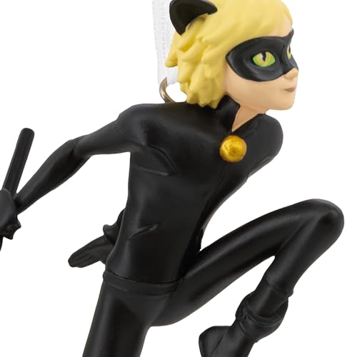 Close-up of the cat hero ornament's green eyes, black mask and gold bell
