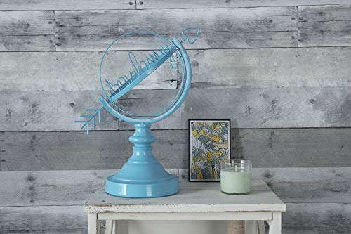 Light blue painted wire globe sculpture with an arrow and script lettering on a white side table