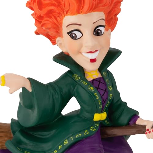 Close-up of the witch ornament's face, toothy grin and green high-collared robe