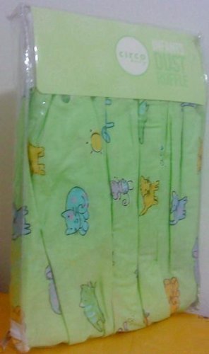 Packaged green crib dust ruffle printed with cats, dogs and suns