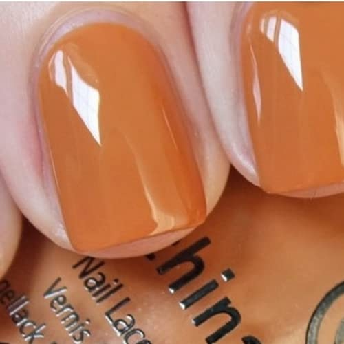 Close-up of nails painted a glossy burnt orange caramel shade
