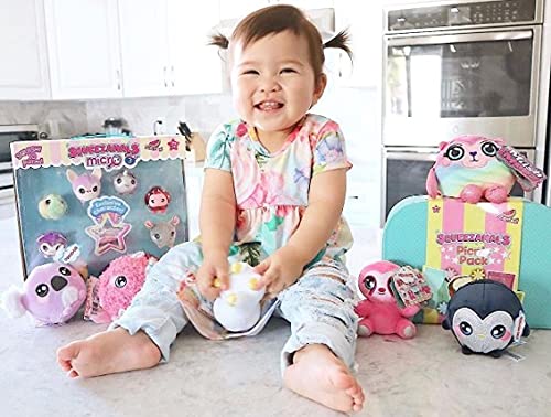 Toddler sitting on a counter with the micro plush set and larger plush toys