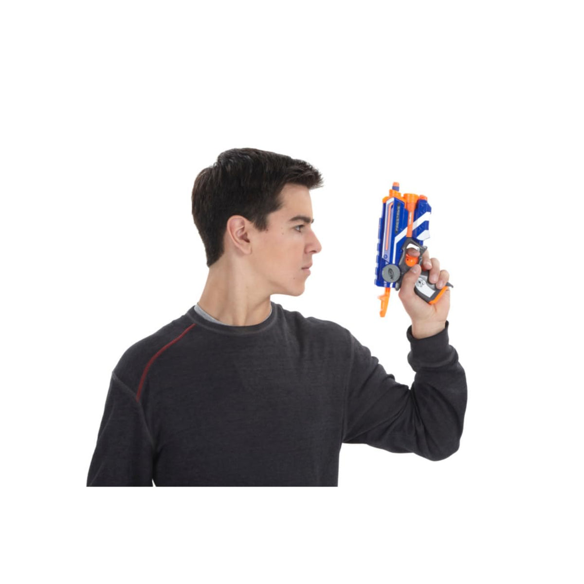 Teen in a dark sweater holding the blue and orange dart blaster upright