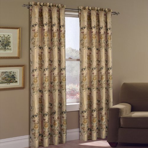 Pair of gold woven curtain panels with red, blue and green floral sprays on a rod