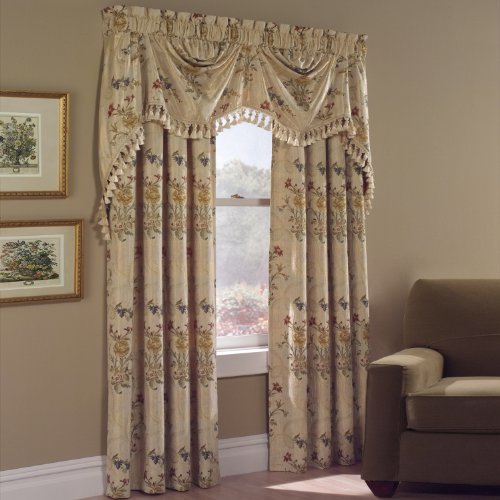 Gold floral woven panels hung with a matching tasselled valance beside an armchair