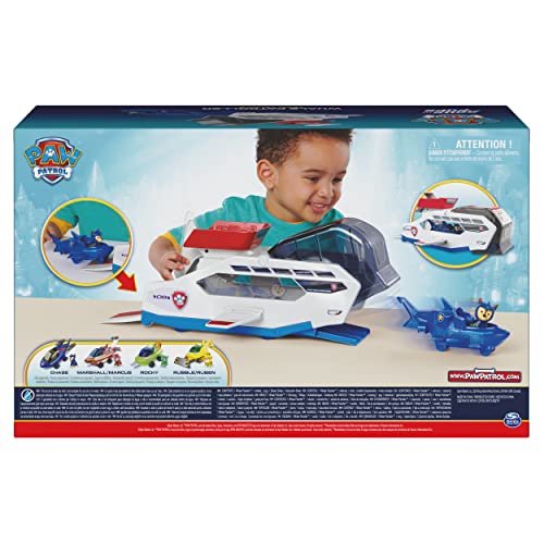 Back of the box with a smiling child playing with the whale vehicle