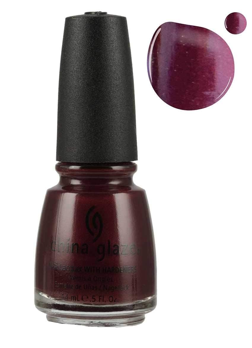 Dark wine polish bottle beside a plum shimmer swatch