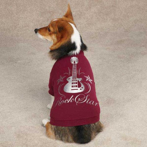 Dog sitting on carpet in a raspberry Rock Star tee with a silver guitar print