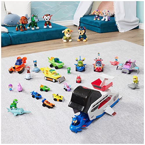 Whale team vehicle on a rug surrounded by many other pup figures and small vehicles