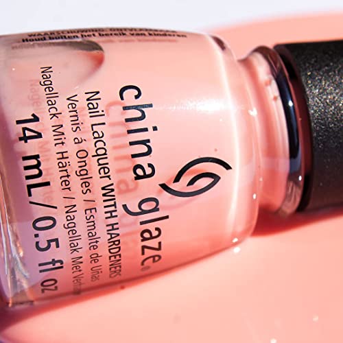 Close-up of a pale pink polish bottle lying in sunlight