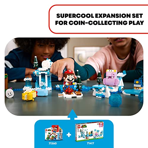 Two children playing with the snowy expansion course and Mario figure on a table