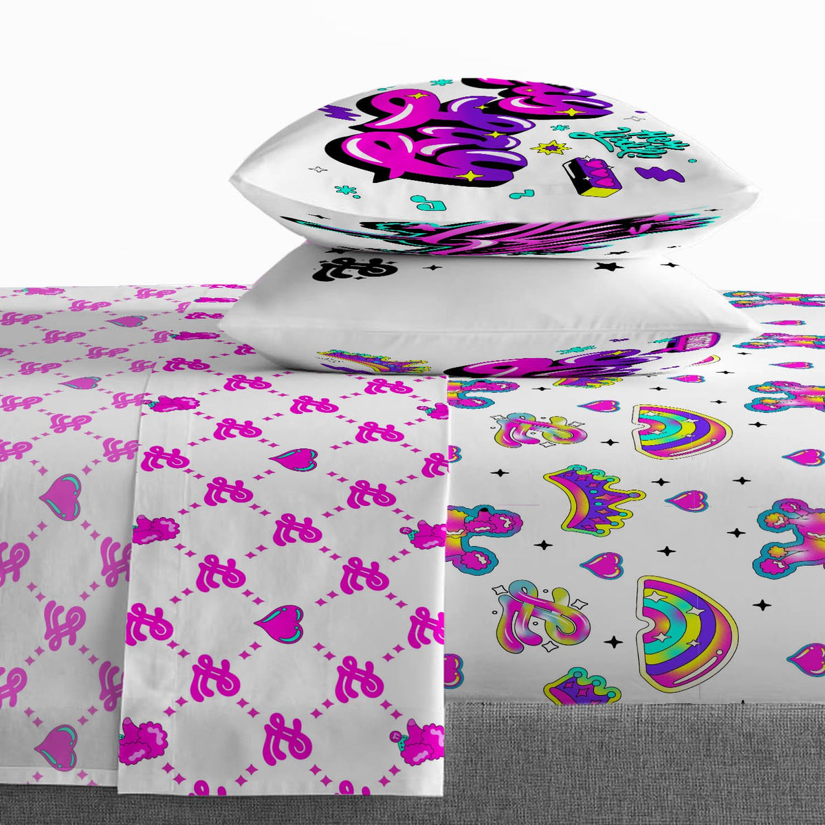 Lay Lay sheet set on a bed: monogram flat sheet, rainbow fitted sheet, two pillowcases