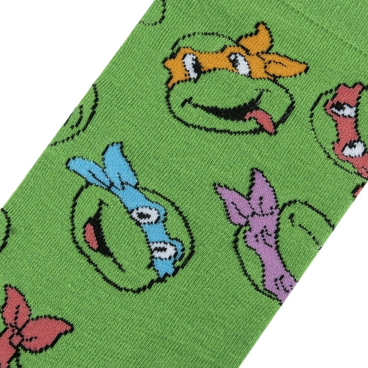 Close-up of the knitted turtle faces with coloured masks on green