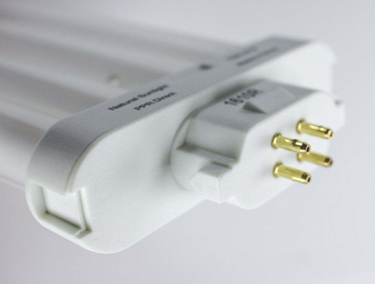 Close-up of the white bulb base and four gold pins on a grey background