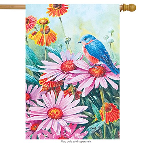 House flag with a bluebird on pink coneflowers among orange blooms, on a wooden pole