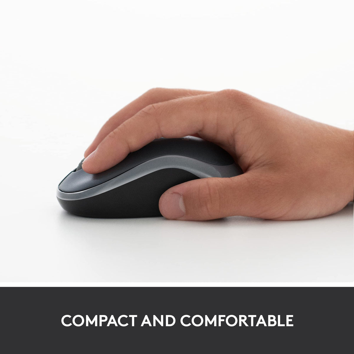 Hand resting on a grey and black compact wireless mouse