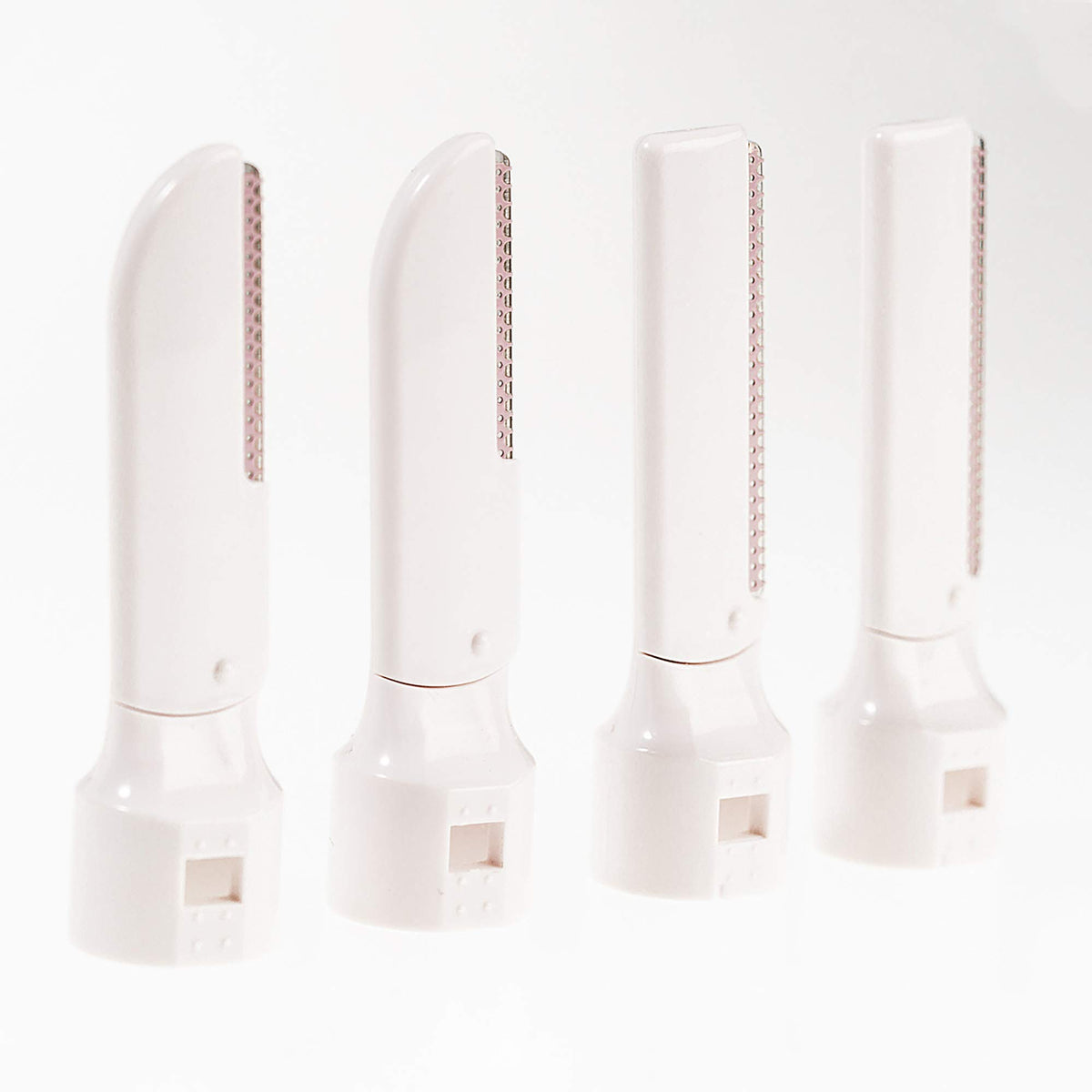 Four refill blade cartridges standing upright, two curved and two straight