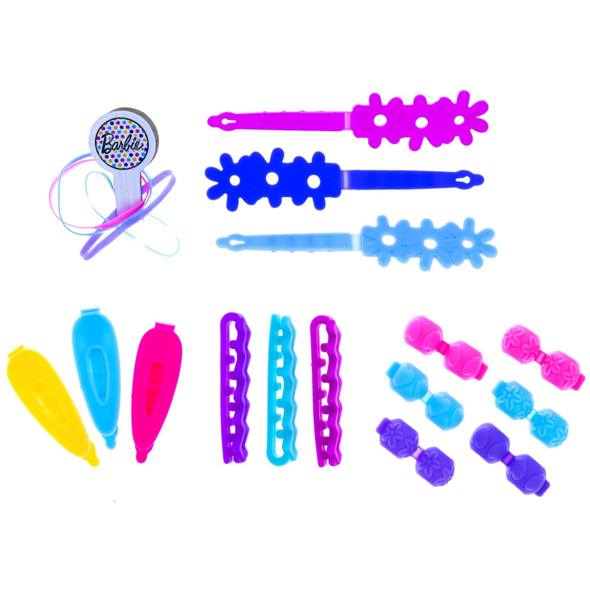 Colourful flower clips, snap clips, beads and hair ties laid out on white