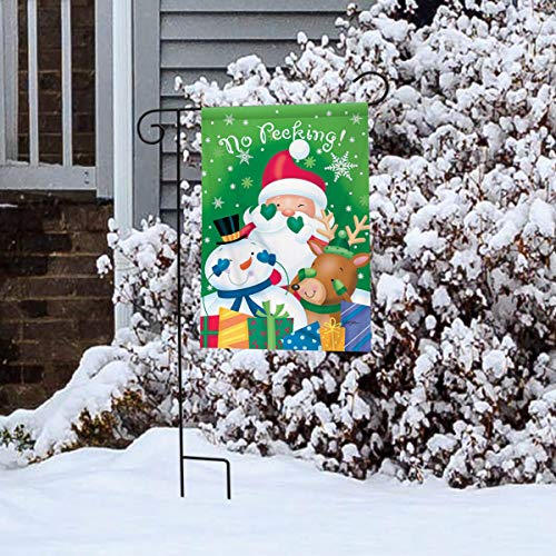 No Peeking Christmas flag on a stand in a snowy yard by a snow-covered bush