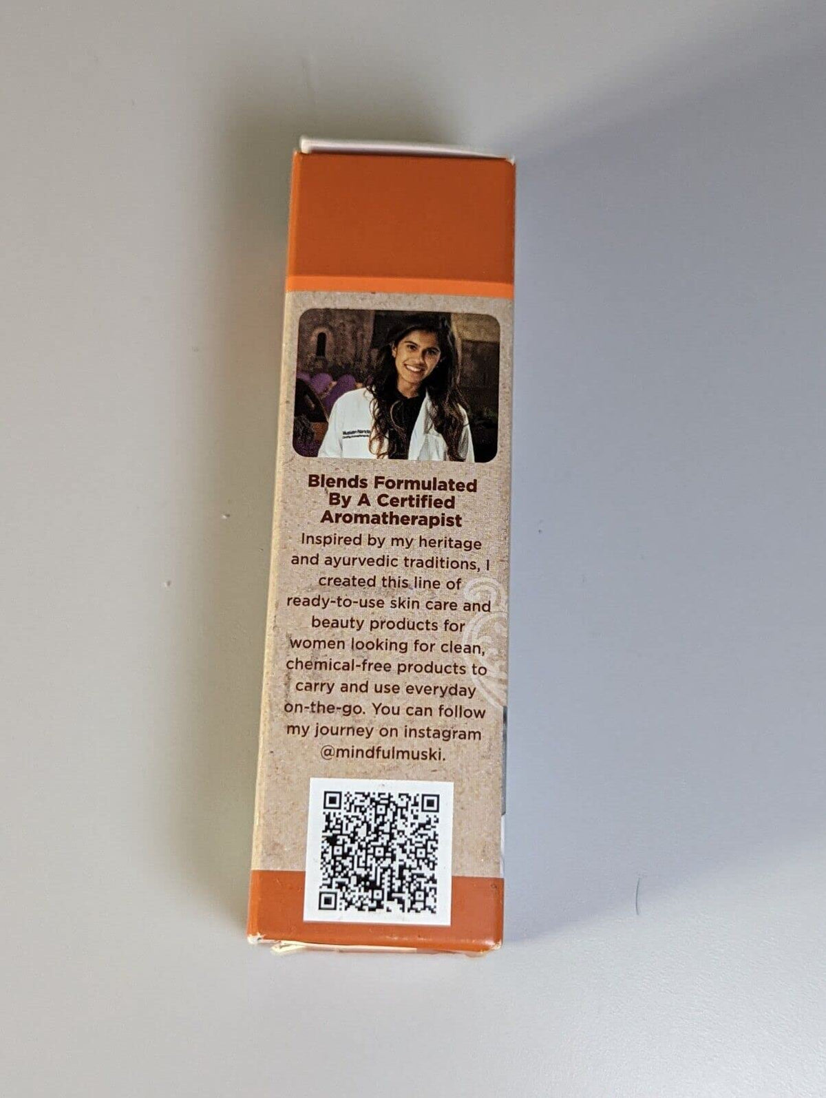 Side of the serum box with a note from the aromatherapist who made the blend and a QR code