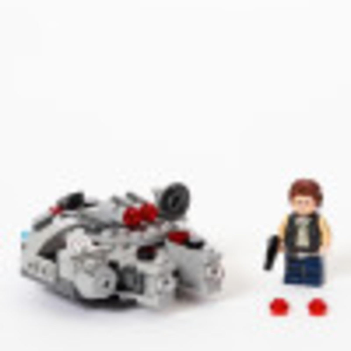 Millennium Falcon microfighter tilted forward beside Han Solo holding a blaster