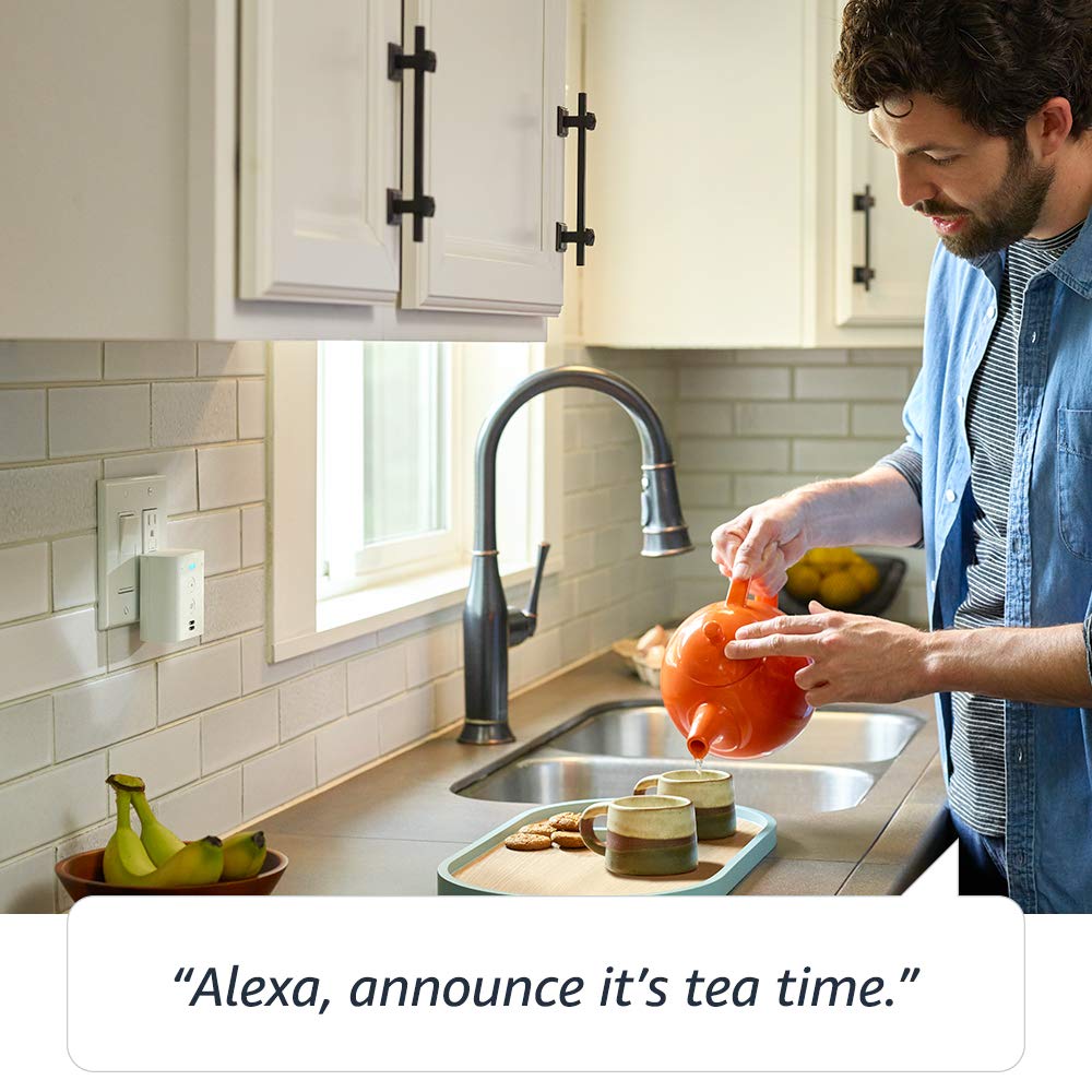Man pouring tea in a kitchen with Echo Flex plugged in by the sink